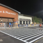 High-visibility crosswalk line striping completed at Walmart Home & Pharmacy in Pottstown, PA by Davis Line Striping. Fresh crosswalk striping at Walmart entrance in Pottstown, PA at night
