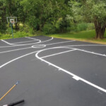 Full residential basketball court with custom striping by Davis Line Striping. Full residential basketball court with fresh white line striping